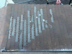 Roofing material inspection of damaged shingles on a residential home Roofing Angels in Los Angeles, CA